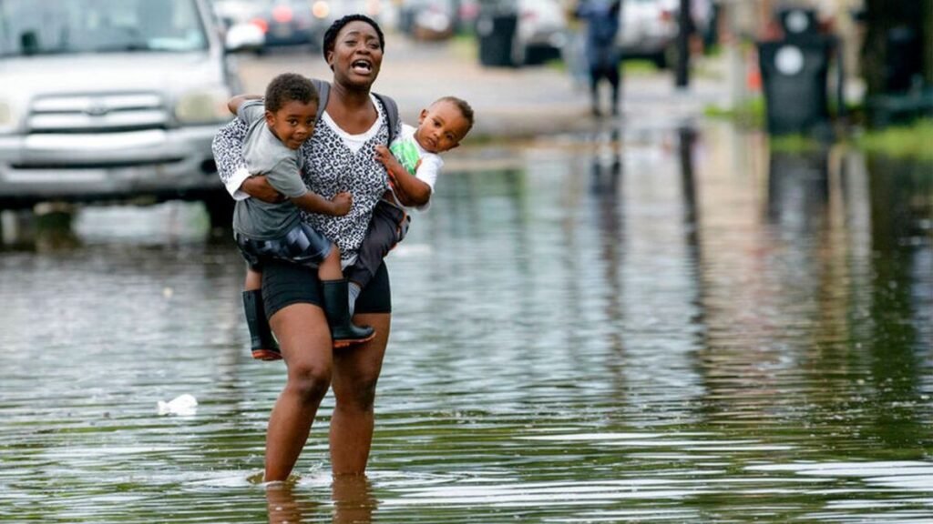 A mother holding two kids in the flood in New York